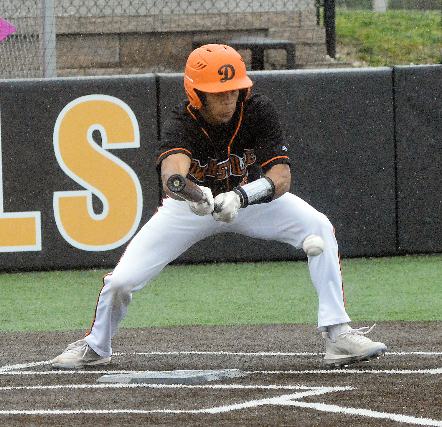Dezmyn Moore squares to bunt during Owensville’s 7-6 loss to Hermann in game one of a Four Rivers Conference (FRC) varsity baseball twin bill at OHS Field last Wednesday in rainy conditions.